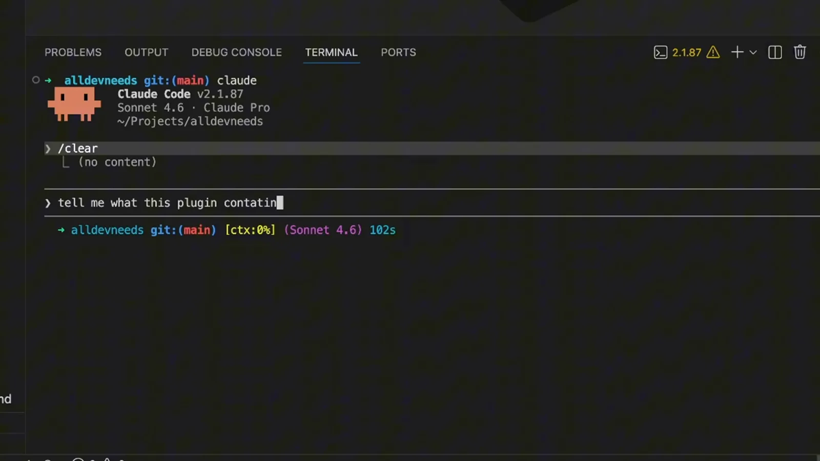 Claude Code panel with the question tell me what this plugin contains, followed by /frontend-design, typed into the input box on a Claude Code v2.1.87 Sonnet 4.6 session